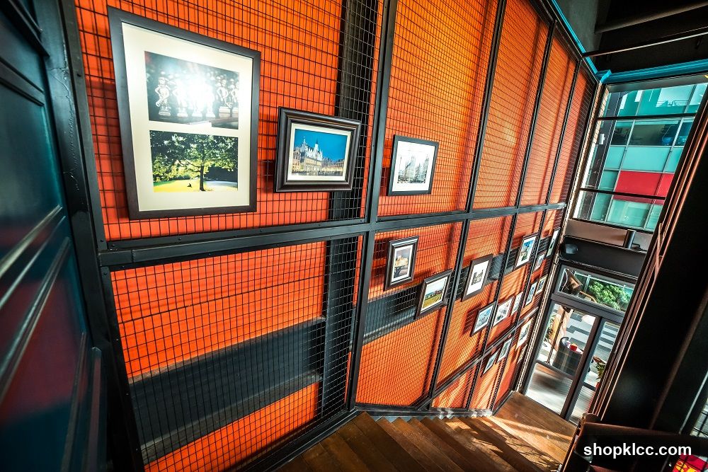 Staircase with Orange Grid Wall and Framed Photos