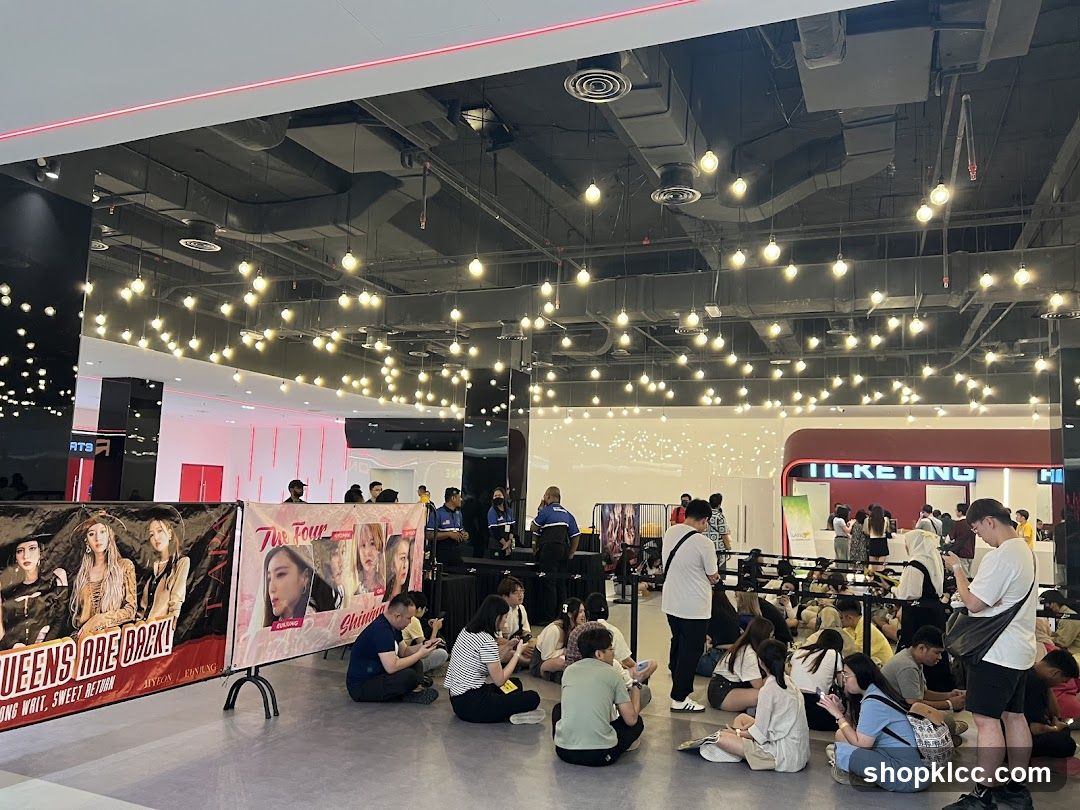 Indoor Event Space with Fans and Merchandise Banners