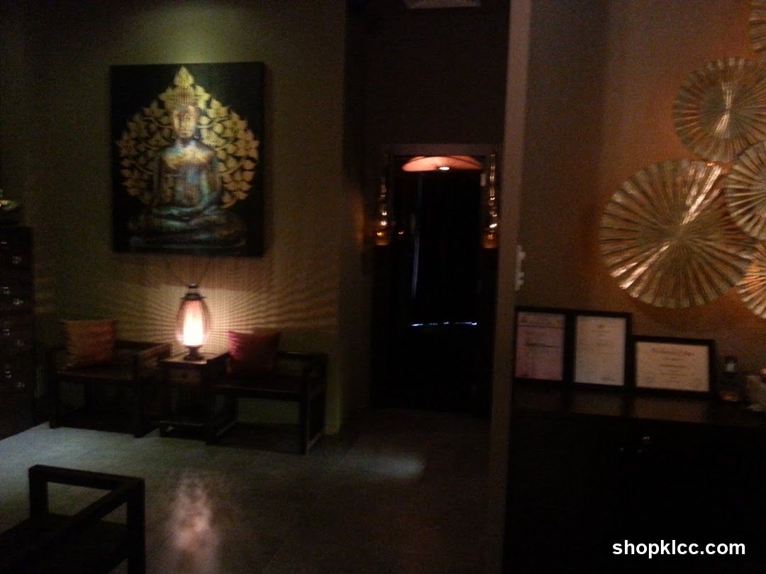 Interior of a dimly lit room with Buddha artwork and certificates