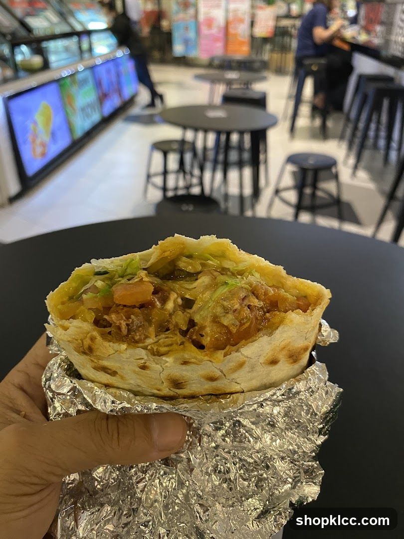 Close-up of a burrito being held by a hand