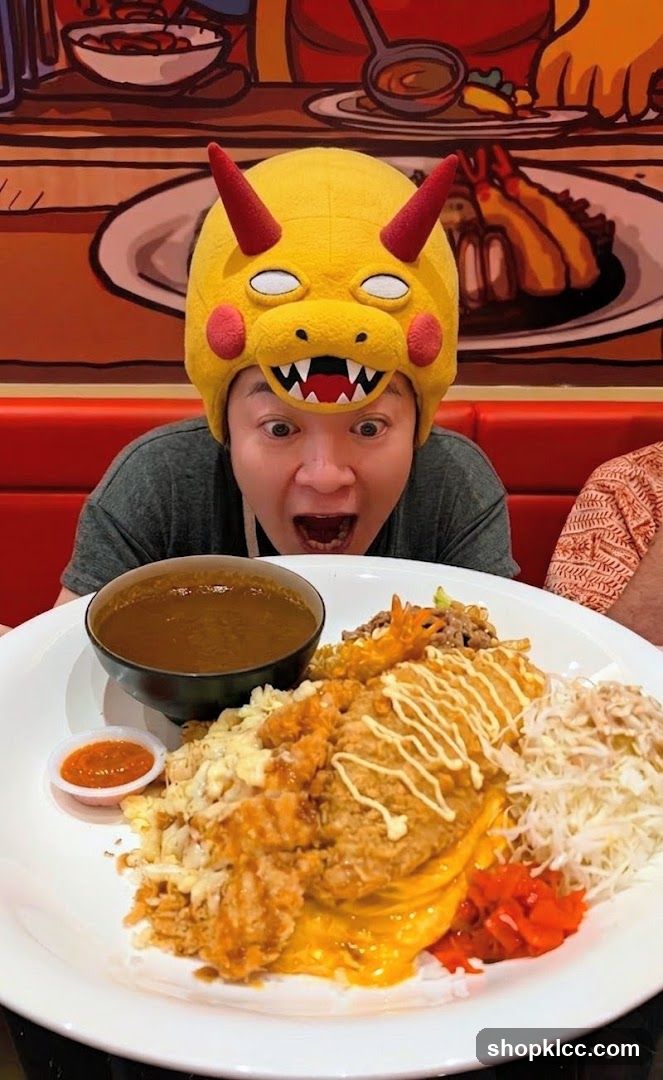 Person wearing a character hat with a large meal