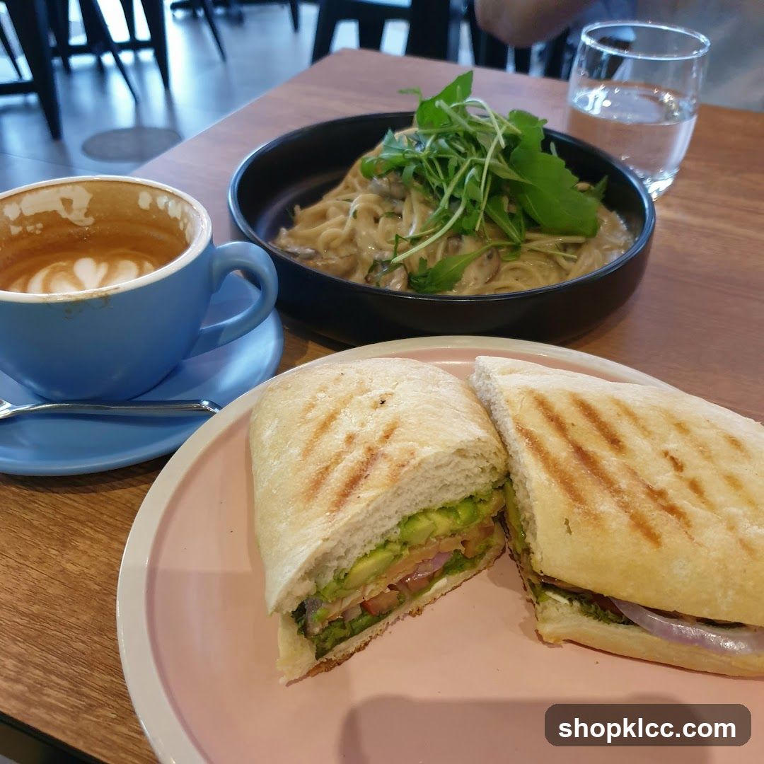 Cafe meal with coffee, pasta, and sandwich