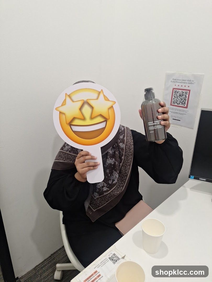Person holding a bottle and an emoji prop