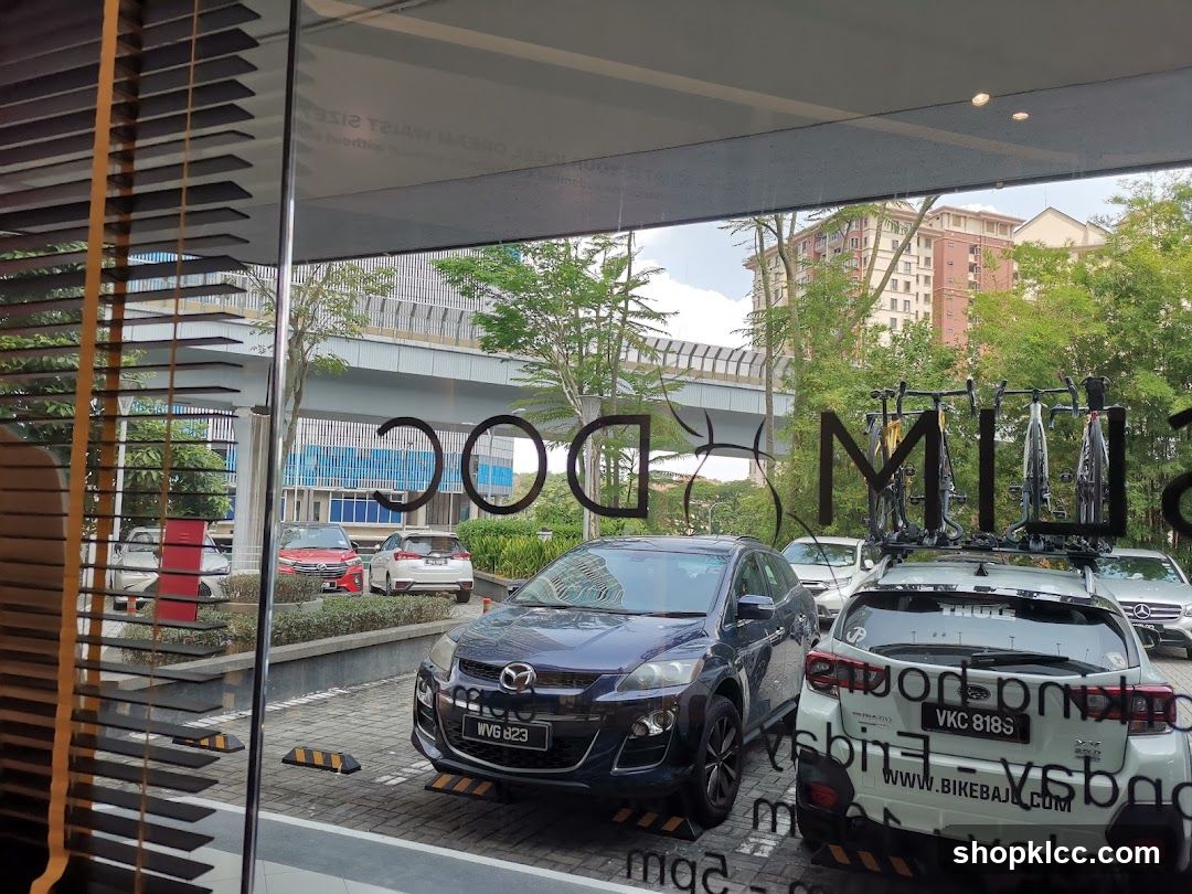 Cars parked outside a building with signage
