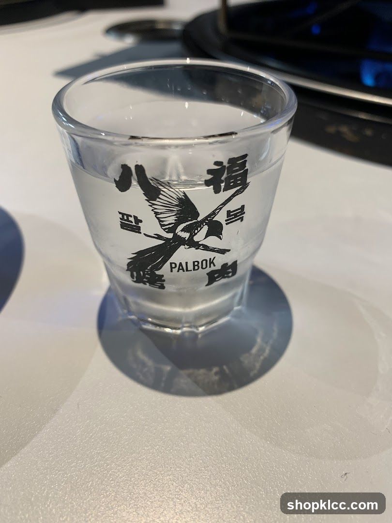 Shot glass with Korean text and magpie design