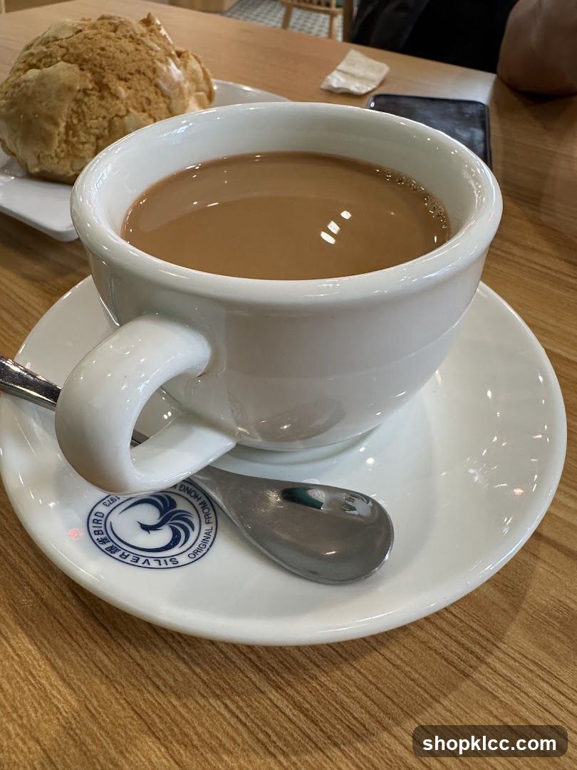 Cup of tea with bun on wooden table