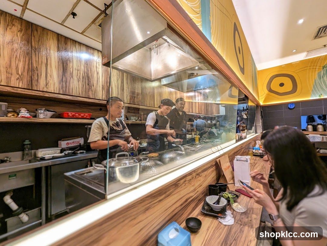 Chefs preparing food behind a glass partition