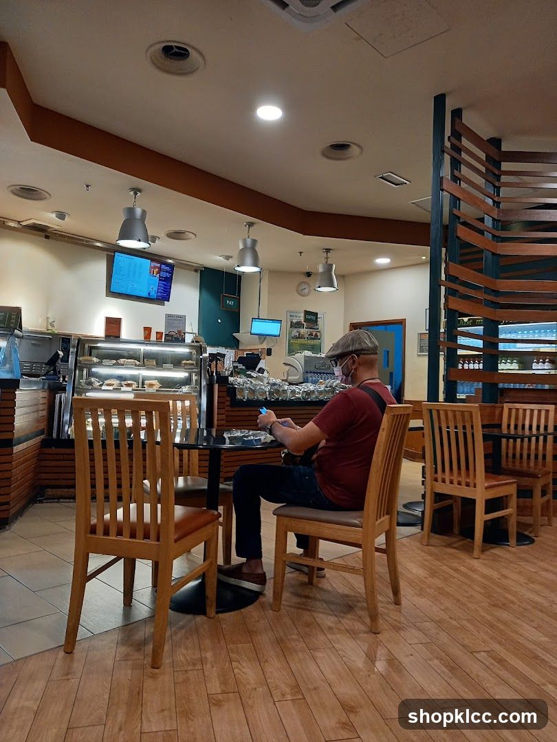 Man Sitting at Cafe Table