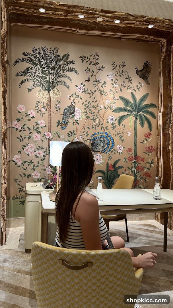 Woman sitting at a table with a mural