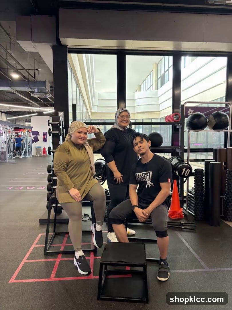Three people posing in a gym