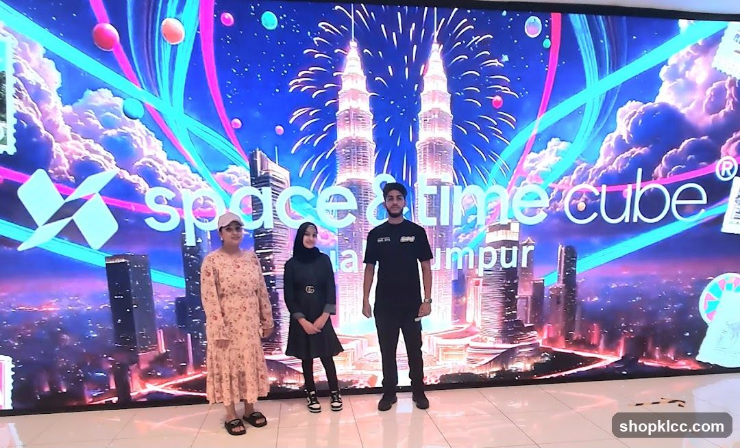 People Posing in Front of a Digital Display