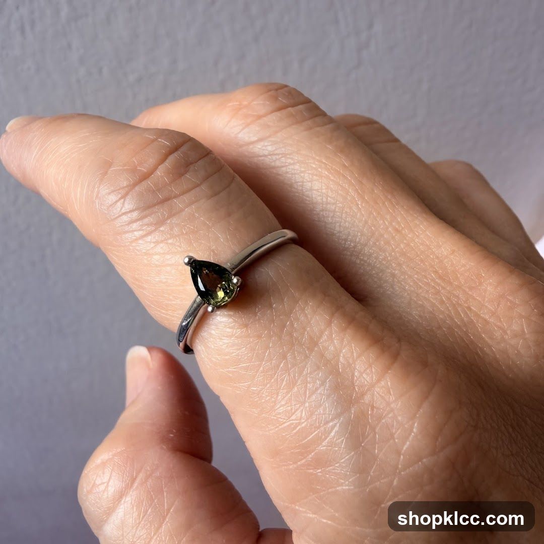 Pear-shaped gemstone ring on a finger