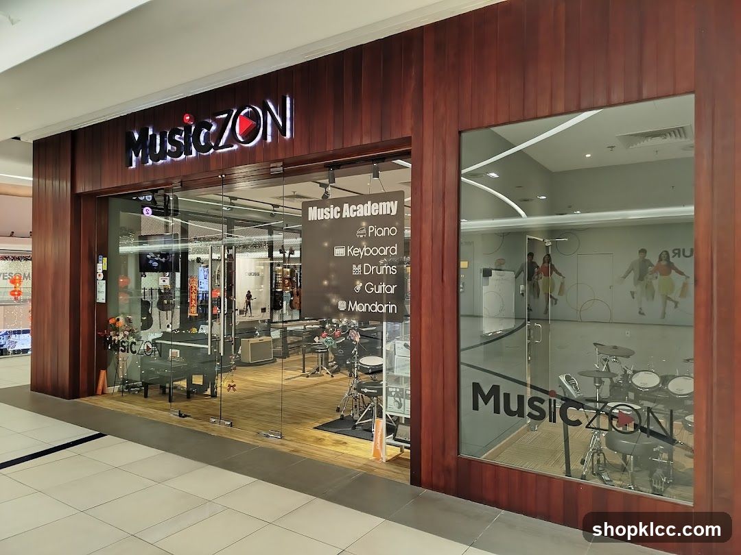 The exterior of a music store and academy with a large glass storefront. The store's name, "MusicZON", is displayed in illuminated letters above the entrance. Inside, musical instruments such as pianos, keyboards, guitars, and drums are visible. A sign inside advertises the "Music Academy" with a list of instruments taught: Piano, Keyboard, Drums, Guitar, and Mandarin.