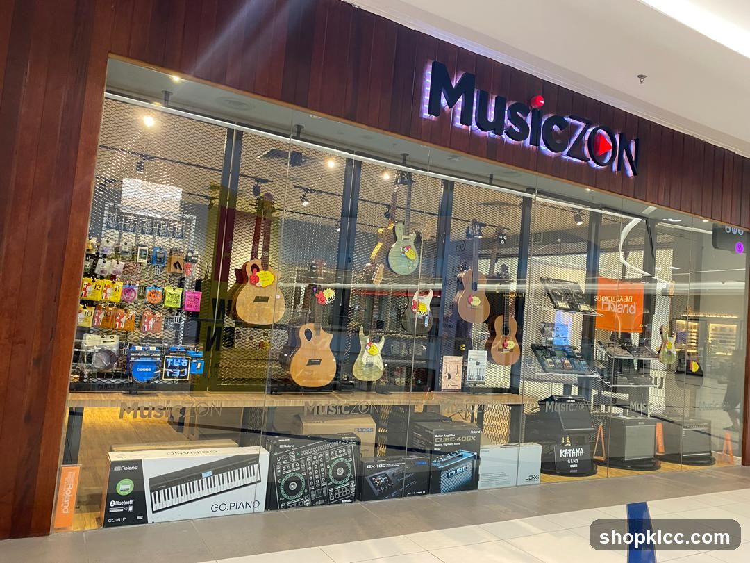 The storefront of a music store called Musiczon. The store features a large glass window displaying various musical instruments, including guitars, keyboards, and amplifiers. The store's name, "Musiczon," is prominently displayed in illuminated letters above the window. Inside, guitars are hung on display, and various accessories and equipment are visible. Boxes for keyboards and amplifiers are placed in front of the window.