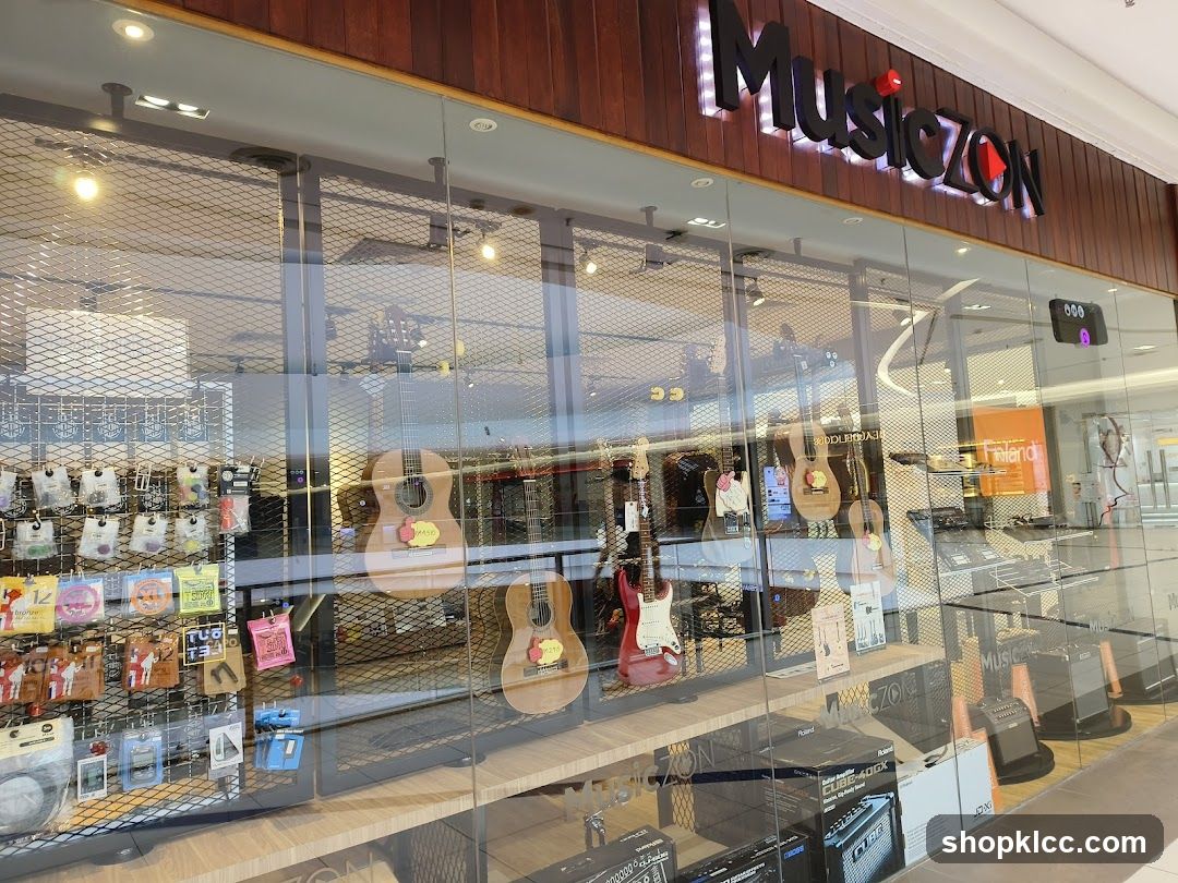 The storefront of a music store with a large glass window displaying various musical instruments and accessories. Guitars, amplifiers, and guitar strings are visible. The store's name, "MusicZON", is prominently displayed in illuminated letters above the entrance.