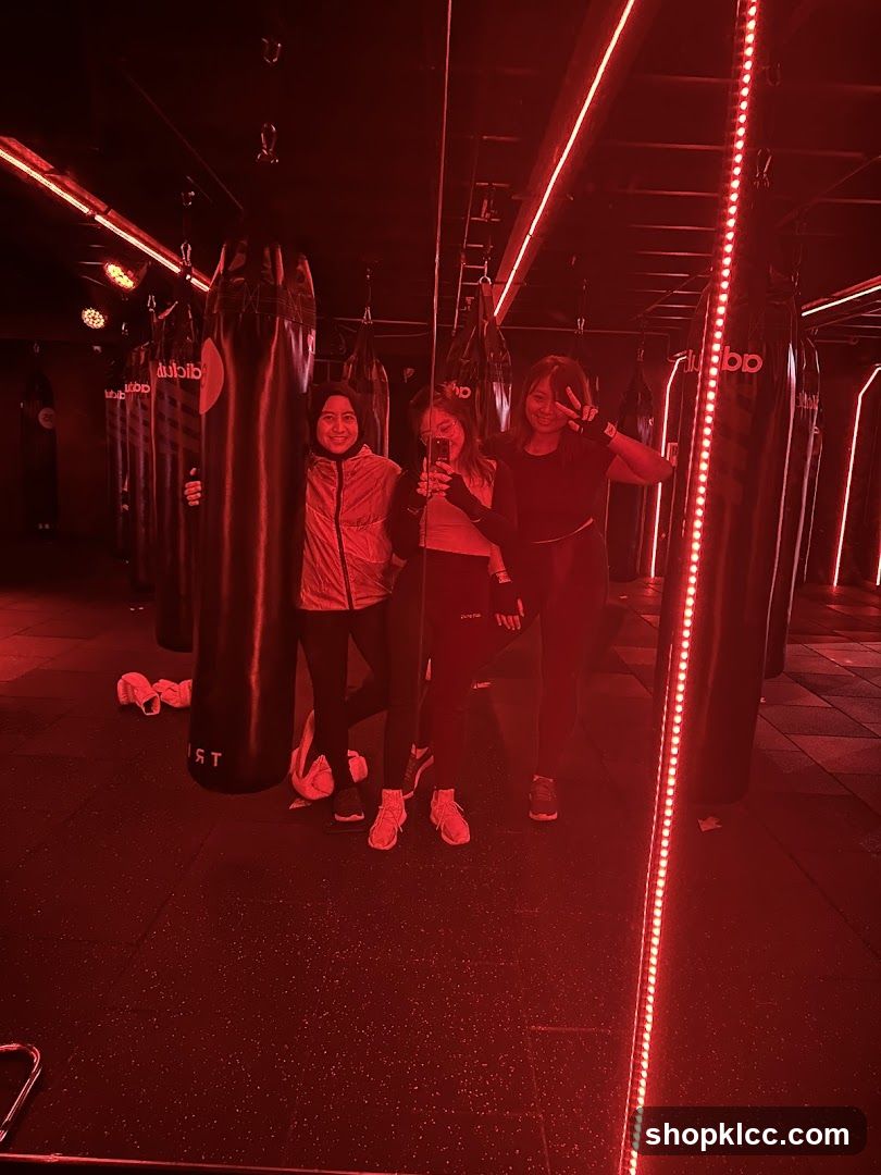 Three women posing in a boxing gym