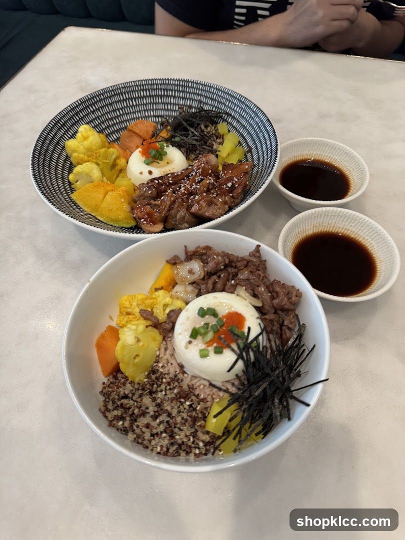 Two bowls of food with dipping sauce
