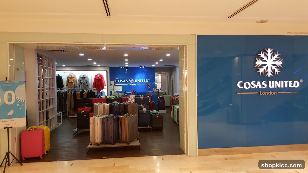 The exterior of a Cosas United London store. The storefront features a large blue facade with the store's logo and name prominently displayed. Inside, the store is filled with luggage and clothing.