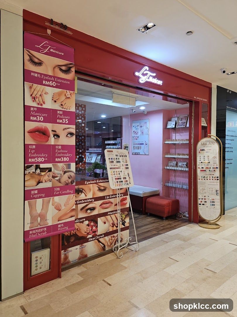 The exterior of a beauty salon with a red facade. A large banner on the left displays services and prices, including Eyelash Extension (RM60++), Manicure (RM30), Pedicure (RM35), Lip Embroidery (RM580++), and Eyebrow Embroidery (RM380). Inside, shelves are stocked with nail polish bottles. A display stand with nail art samples is positioned near the entrance.