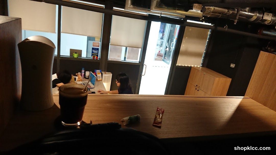 Interior of a cafe with a person working