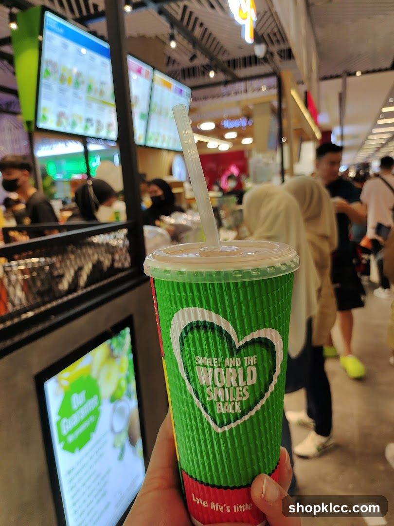 Green cup with straw and heart logo