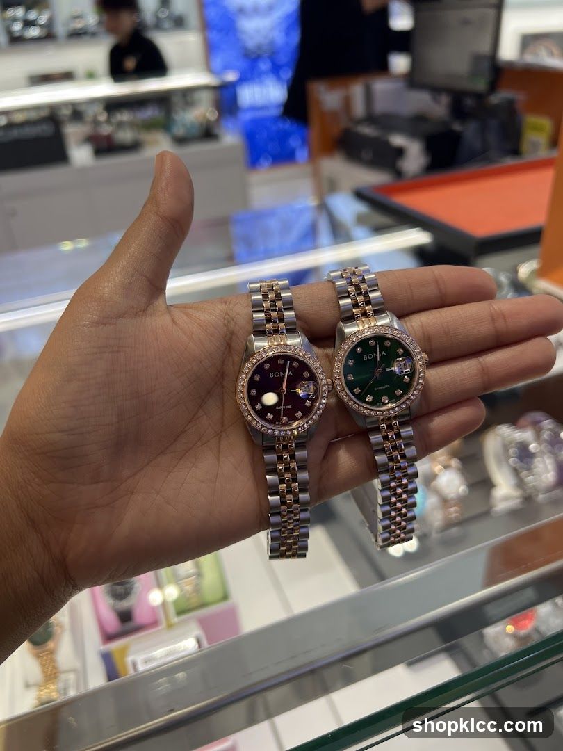 Two watches held in a hand
