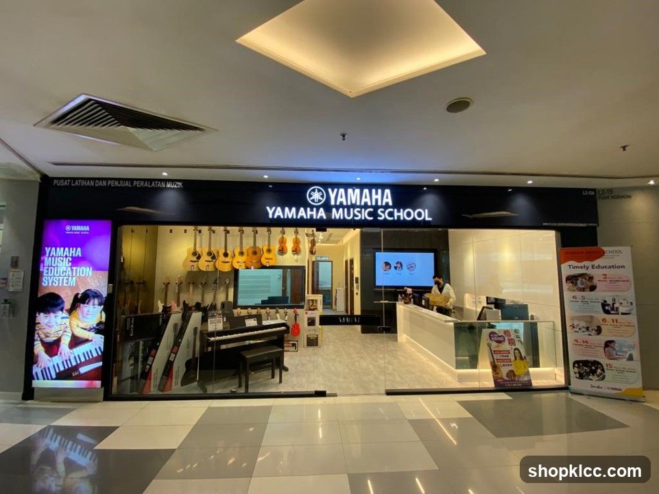 The exterior of a Yamaha Music School, featuring a prominent sign with the Yamaha logo and text. The storefront displays various musical instruments, including guitars and pianos, and a digital screen showing educational content.