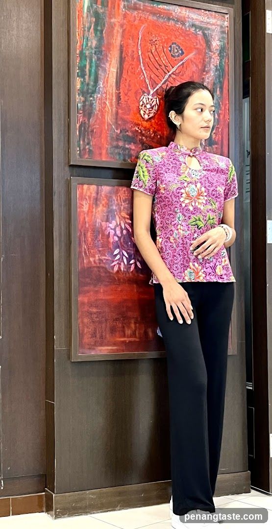 Woman in traditional attire posing indoors