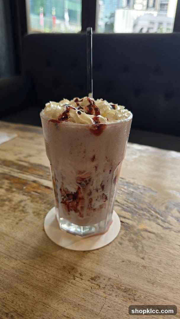 Strawberry milkshake with whipped cream and chocolate drizzle