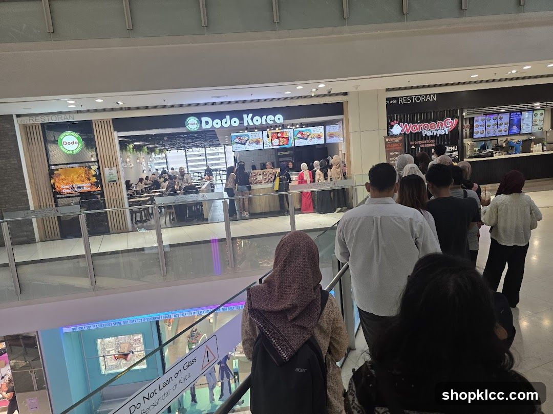 People queuing at food stalls in a mall