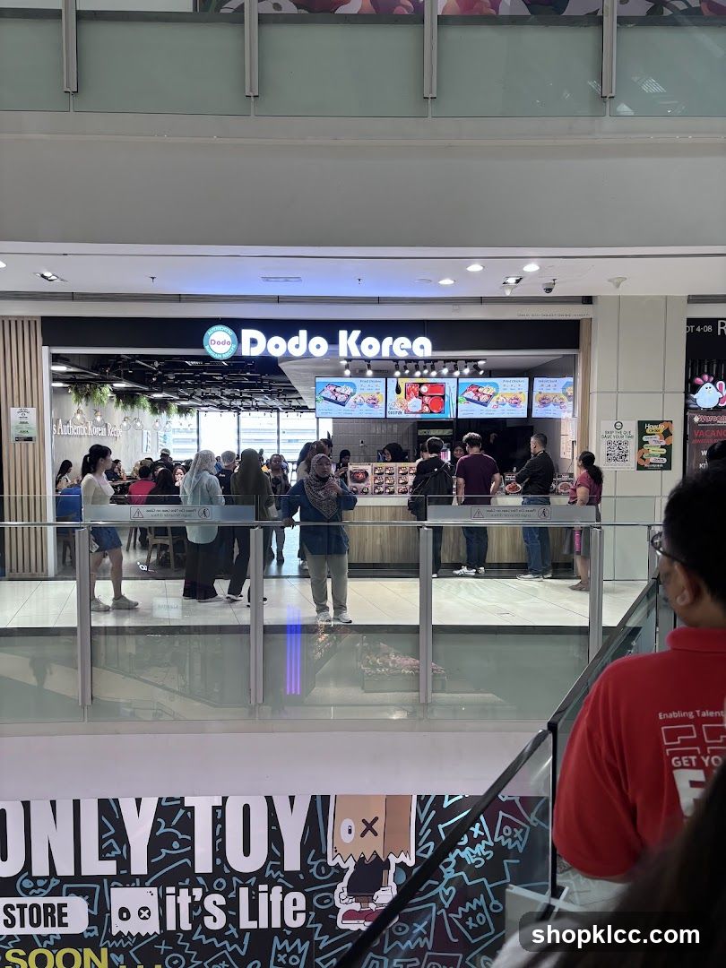 A storefront for Dodo Korea, a Korean restaurant, with a prominent sign and menu displays. People are seen queuing and ordering.