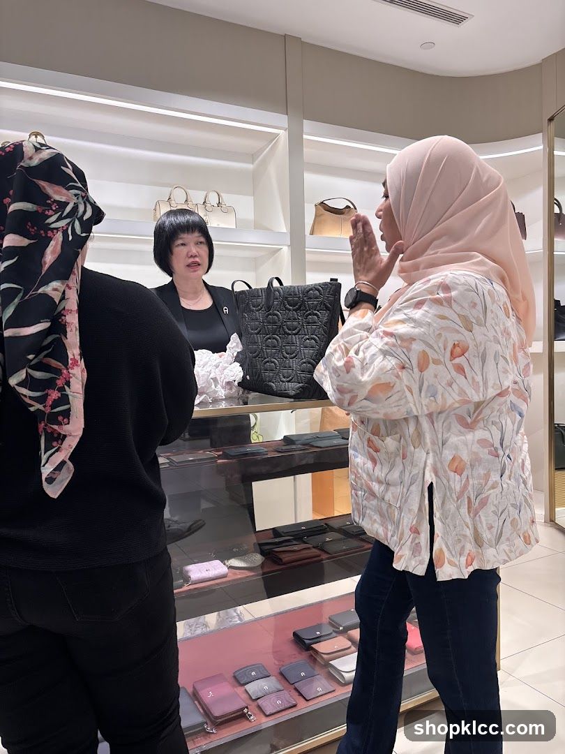 Customers interacting with a sales associate in a luxury goods store