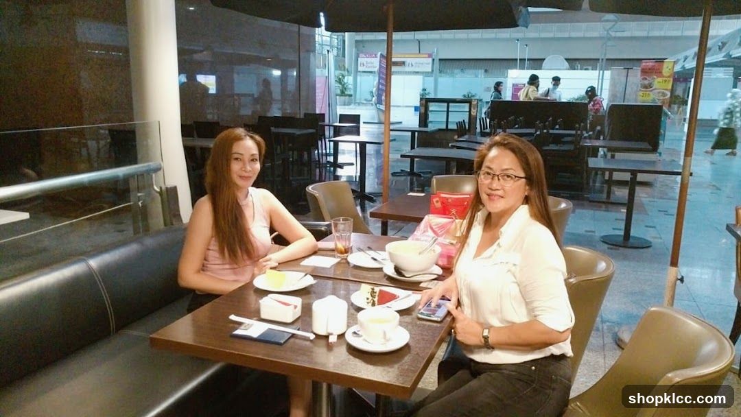Two Women Enjoying Dessert at a Cafe