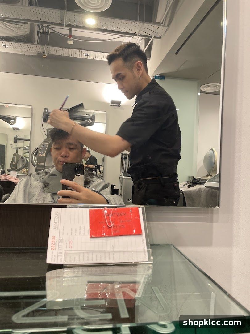 Hairdresser cutting client's hair