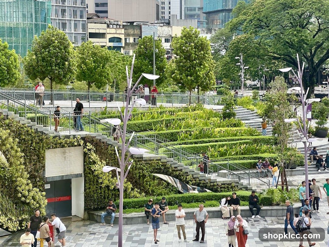 People in a park with tiered gardens and modern architecture