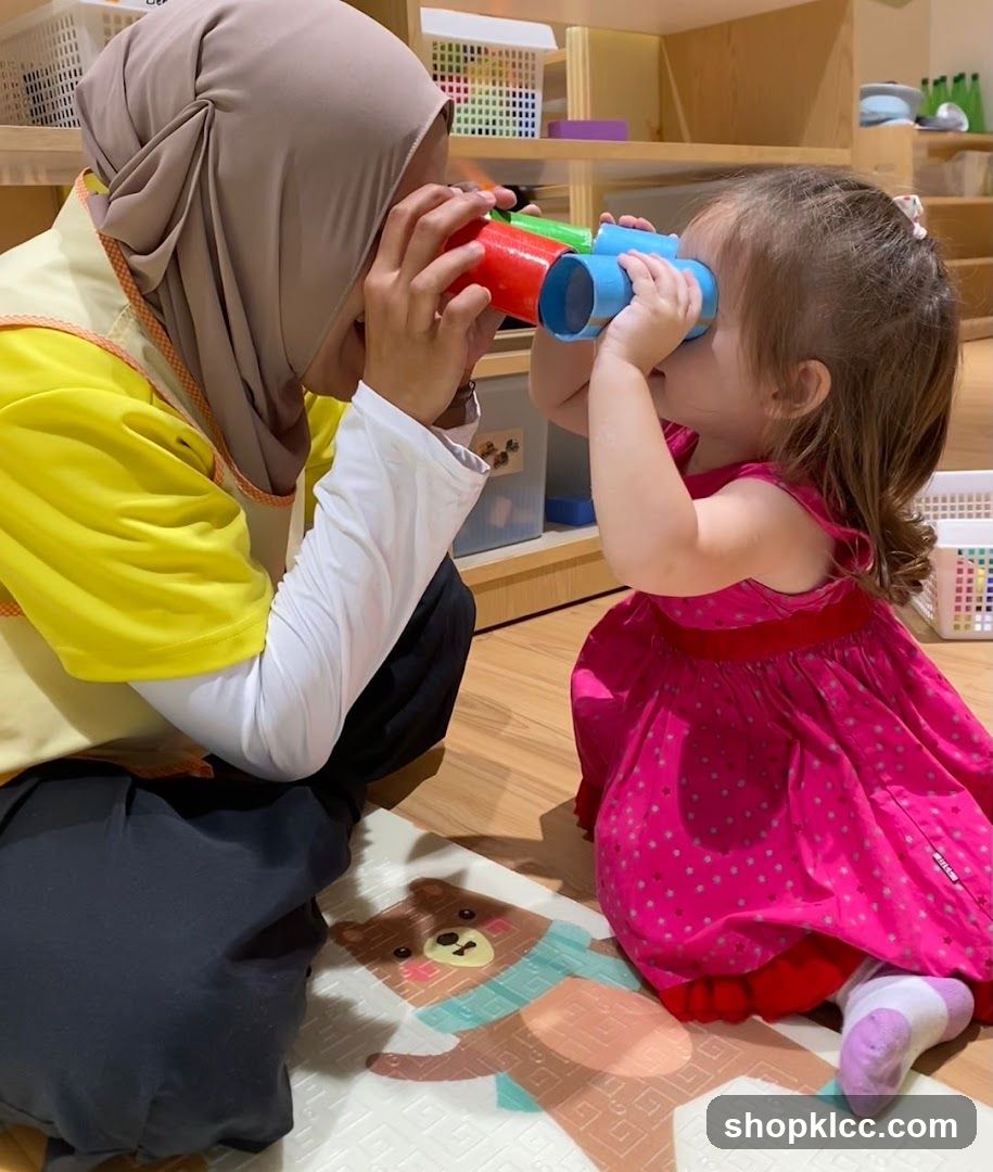 Teacher and child looking through toy binoculars
