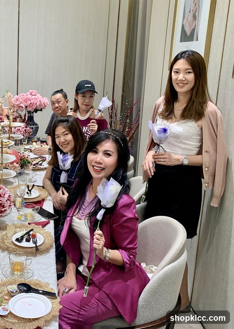 Women Posing with Flowers at a Table
