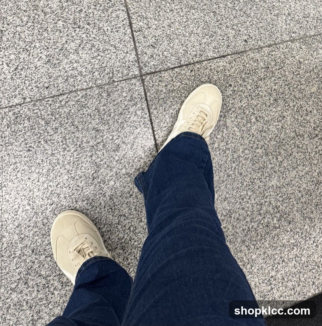 Person wearing sneakers and jeans