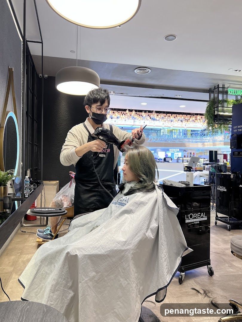 Hairdresser drying client's hair