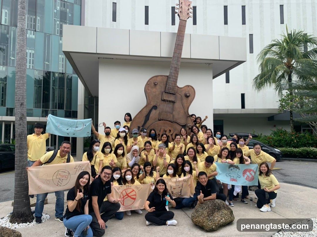 Group Poses with Guitar Sculpture