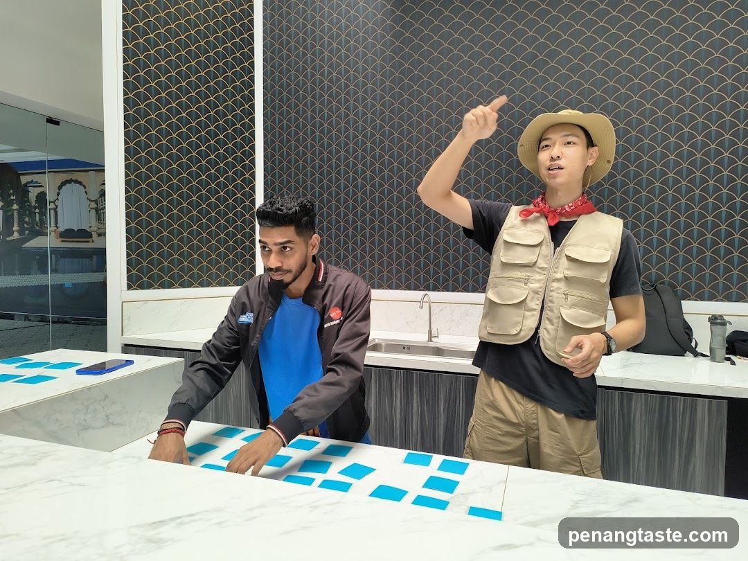 Two men in a room with blue cards