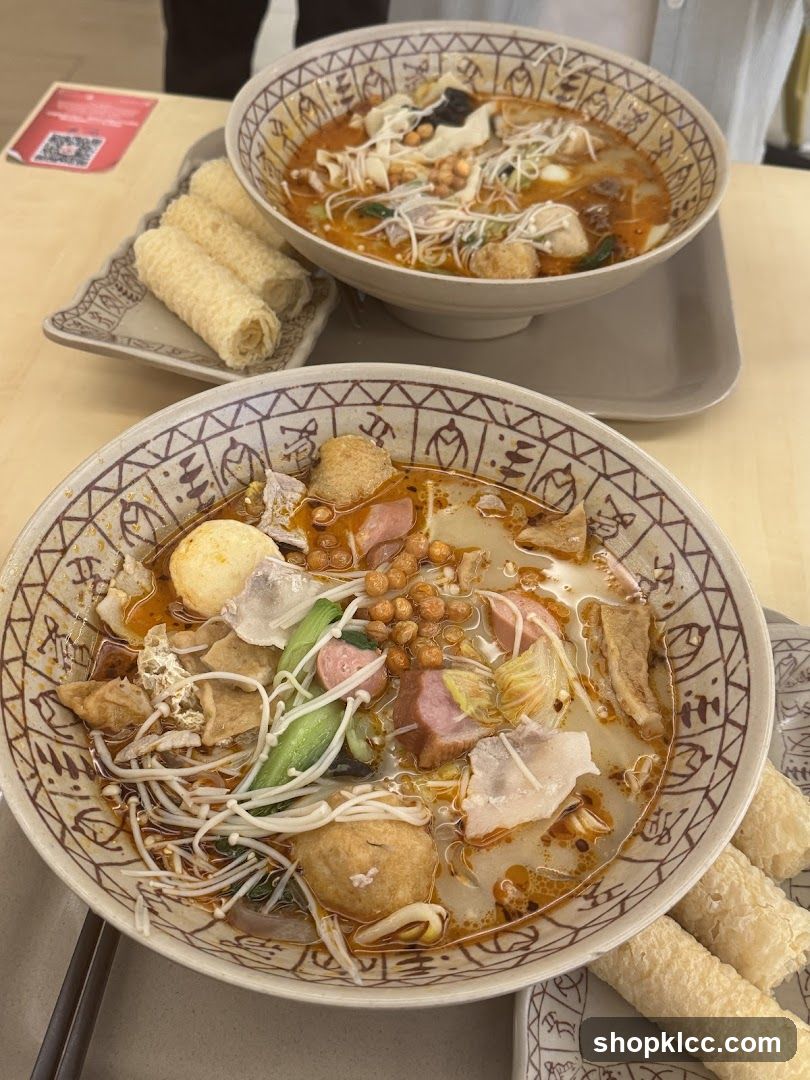 Two bowls of spicy soup with various ingredients