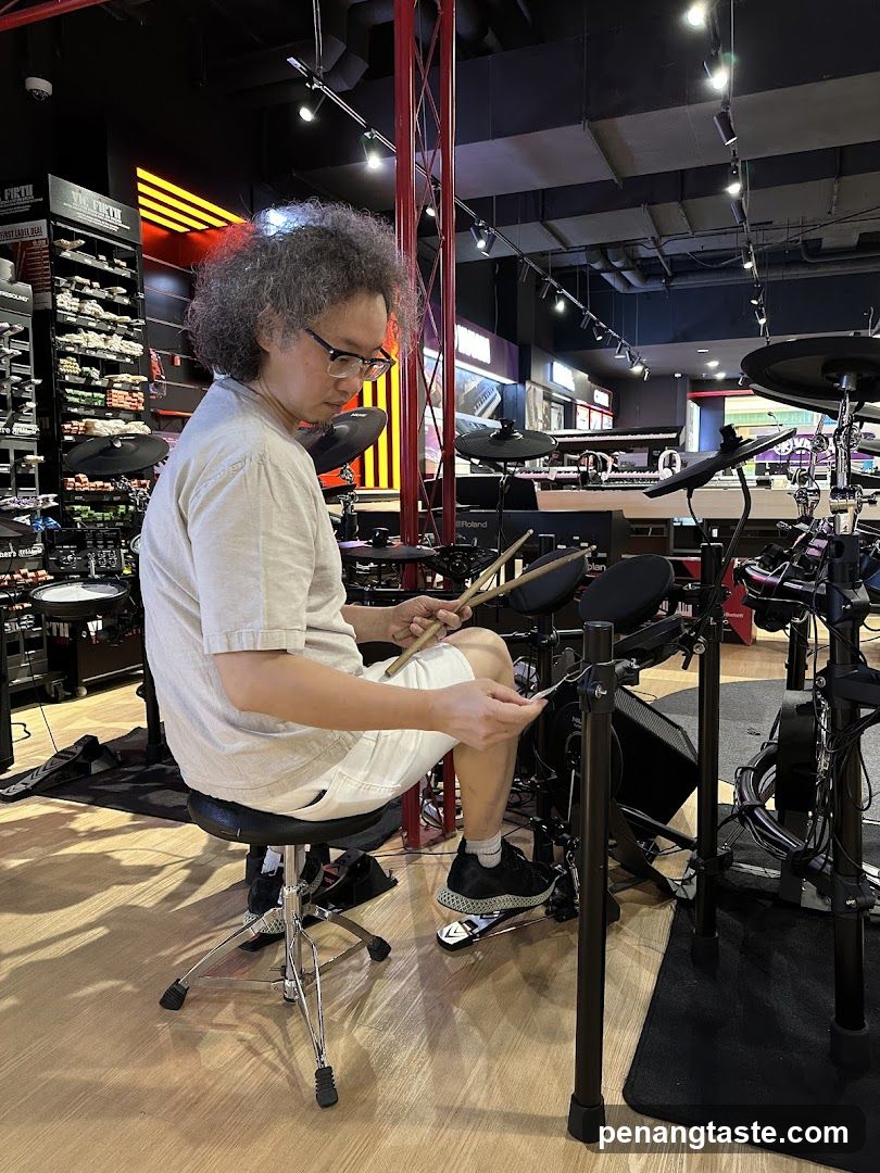 Man playing electronic drums in a music store