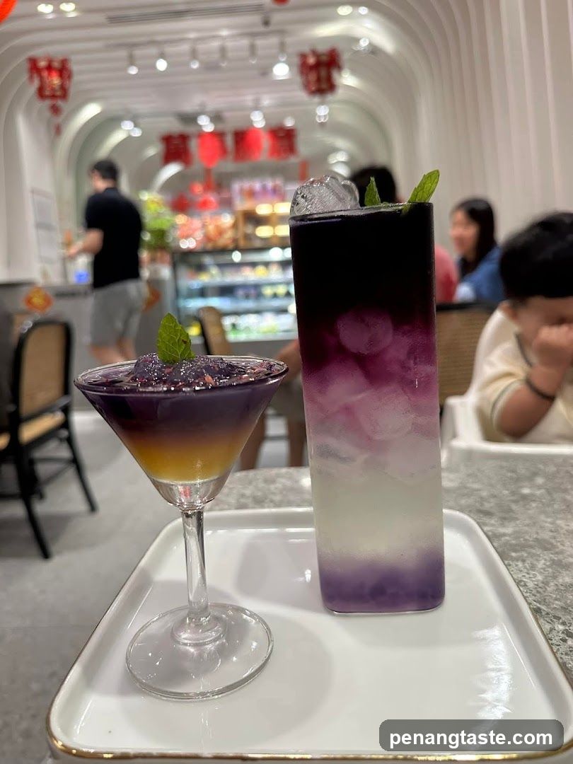 Two colorful layered drinks on a tray