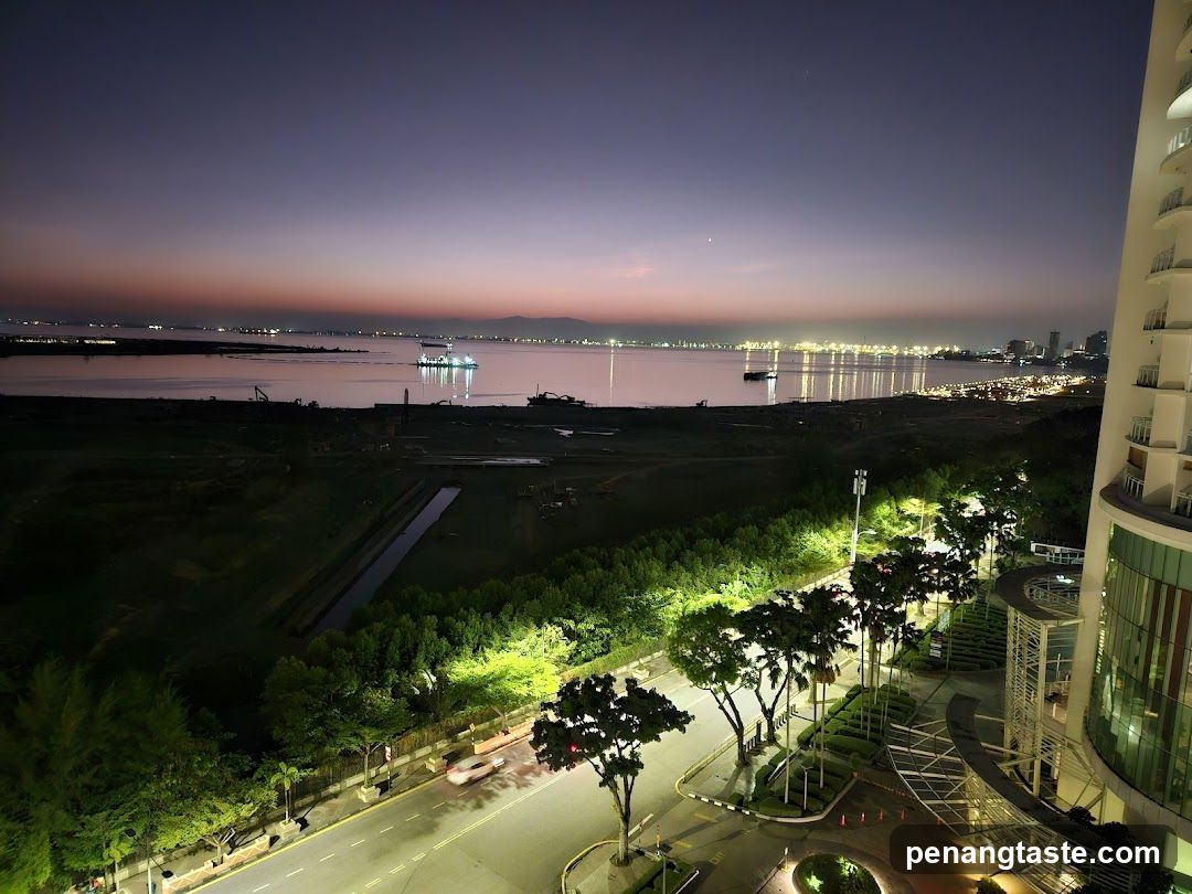 Night view of a coastal city with a modern building