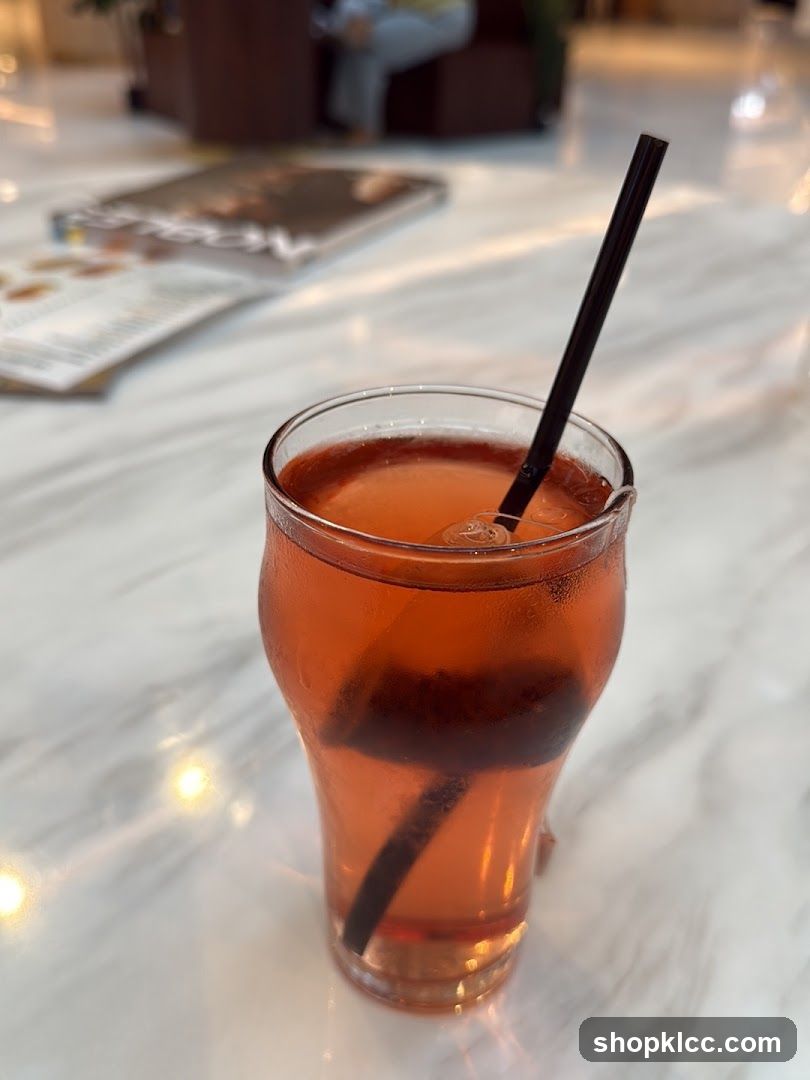 Red Drink with Straw on Marble Table