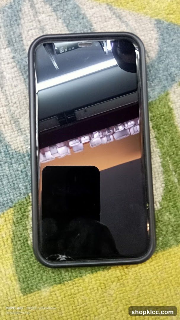Smartphone with cracked screen on patterned fabric