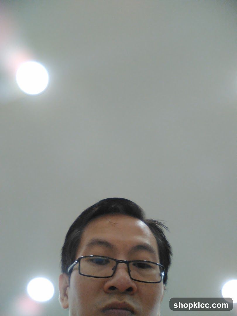 Low-angle selfie of a man with glasses