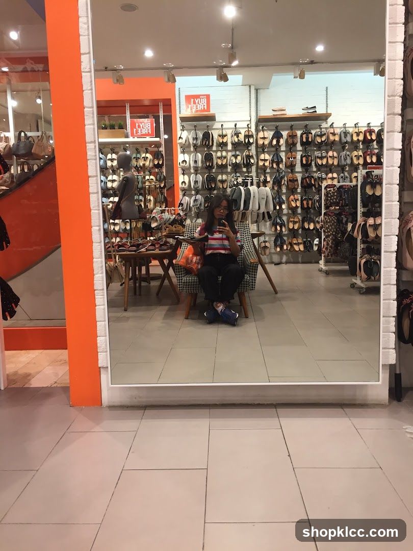 Woman taking a mirror selfie in a shoe store