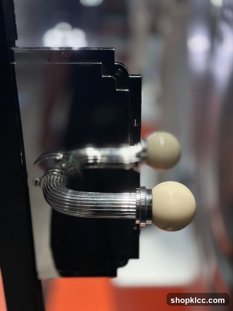 Close-up of a metallic handle with spherical knobs